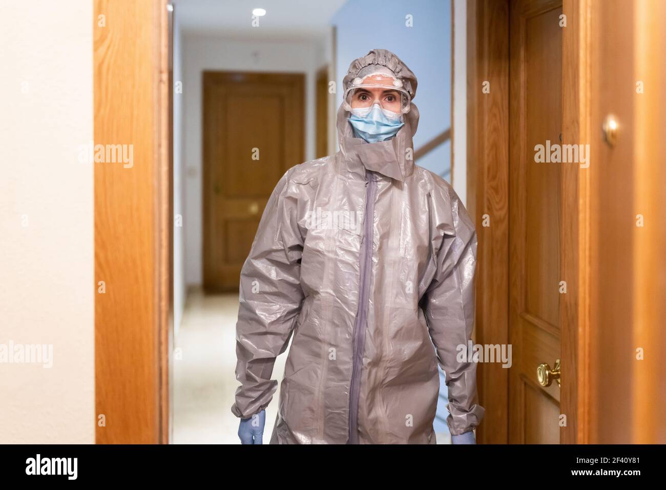 Doctor in PPE Personal Protective Equipment coming into the house to see a patient. Doctor in PPE Personal Protective Equipment coming into the house Stock Photo