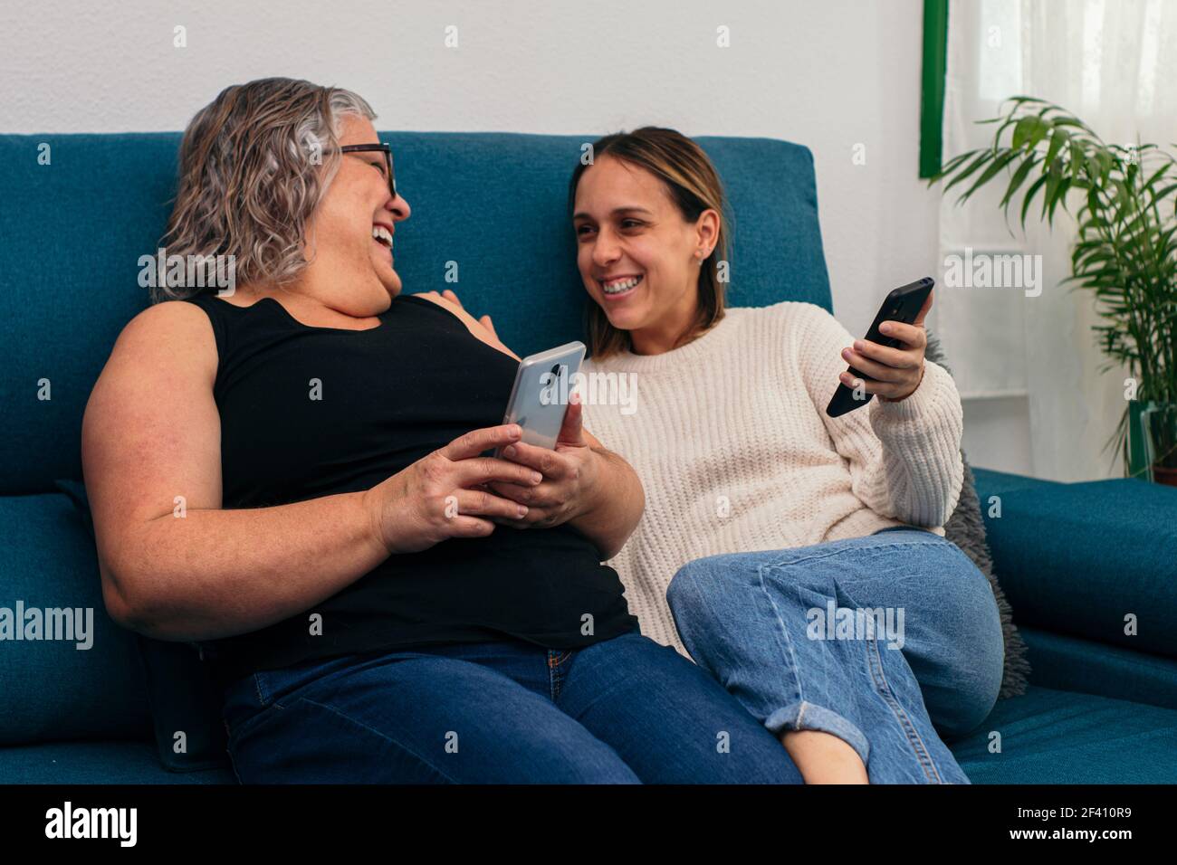 Elderly mother and young daughter make a video call with their mobile ...