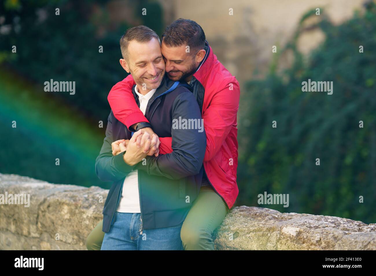 Gay couple in a romantic moment in a beautiful place near the river. Homosexual relationship concept.. Gay couple in a romantic moment outdoors Stock Photo