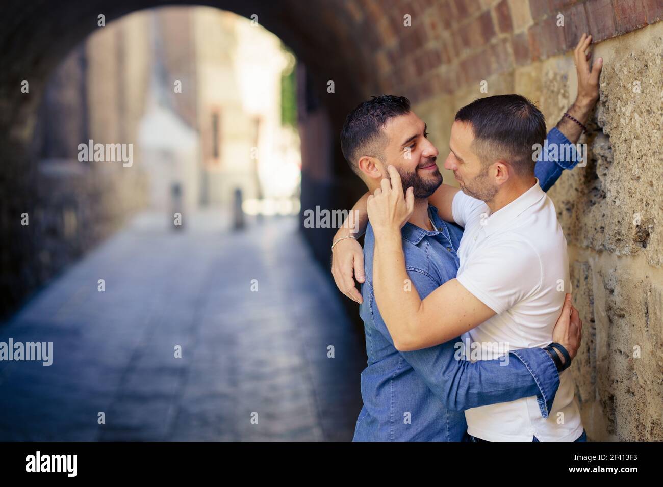 Gay couple hugging in a romantic moment. Homosexual relationship concept.. Gay couple hugging in a romantic moment outdoors Stock Photo