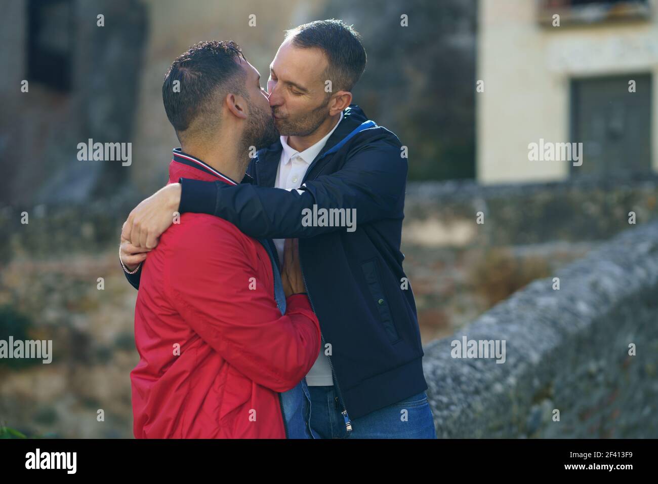 Gay couple kissing a beautiful place near the river. Homosexual relationship concept.. Gay couple kissing a beautiful place near the river. Stock Photo