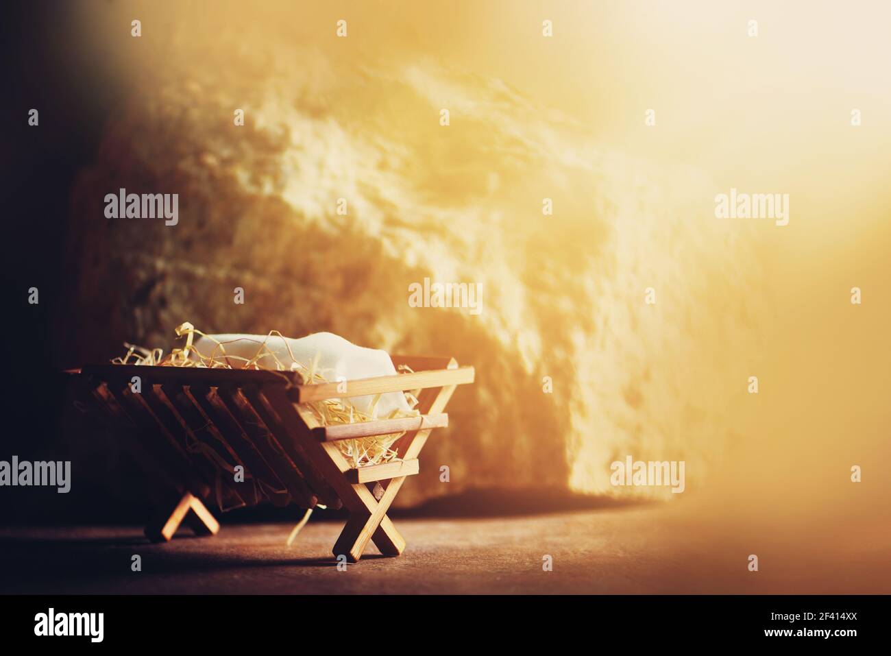 Wooden manger and star of Bethlehem in cave, nativity scene background. Christian Christmas