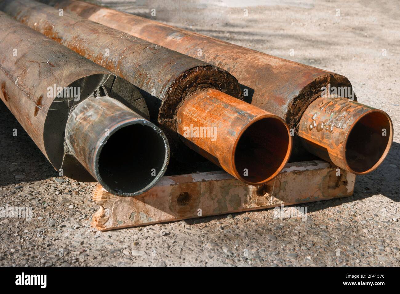 Old Hot Water Pipes With Thermal Insulation Ends Extruded from trench