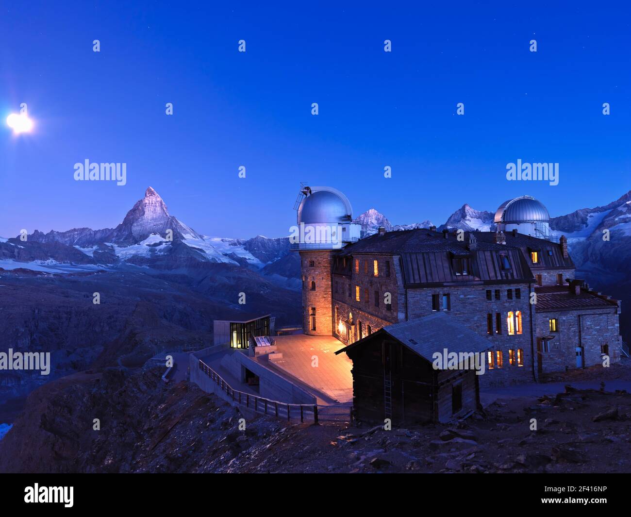 Switzerland, Zermatt, moon setting at dawn over the Matterhorn and the Kulm Hotel at the Gornergrat Stock Photo