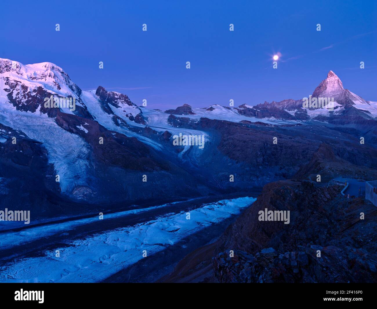 Switzerland,Zermatt, moon setting at dawn over the Matterhorn and the Gorner Glacier at the Gornergrat Stock Photo