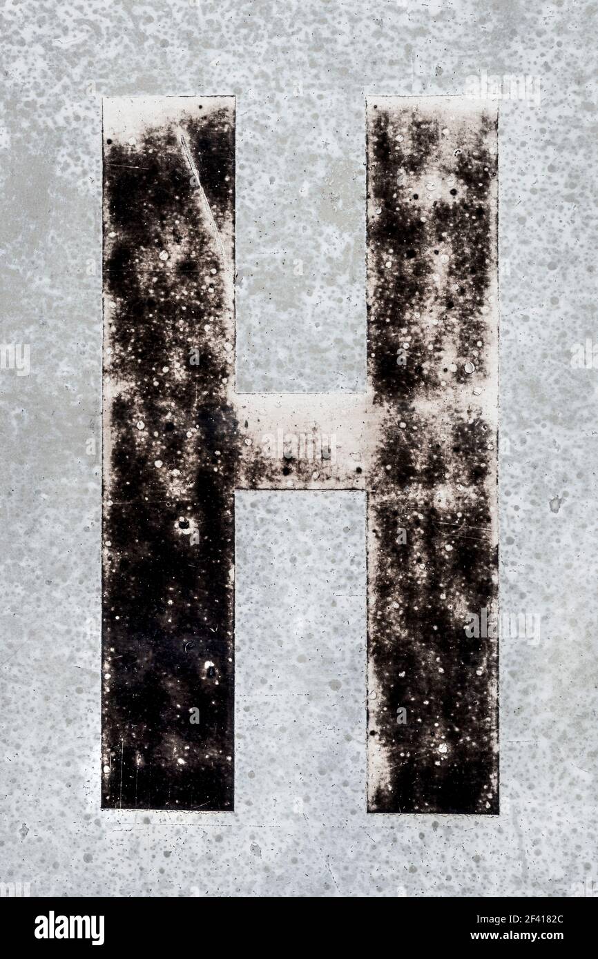 Weathered black letter H of a signpost Stock Photo Alamy