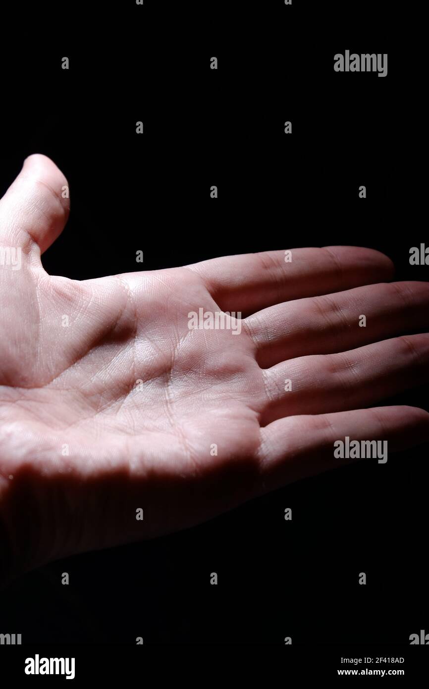 Open palm in the dark. Stock Photo