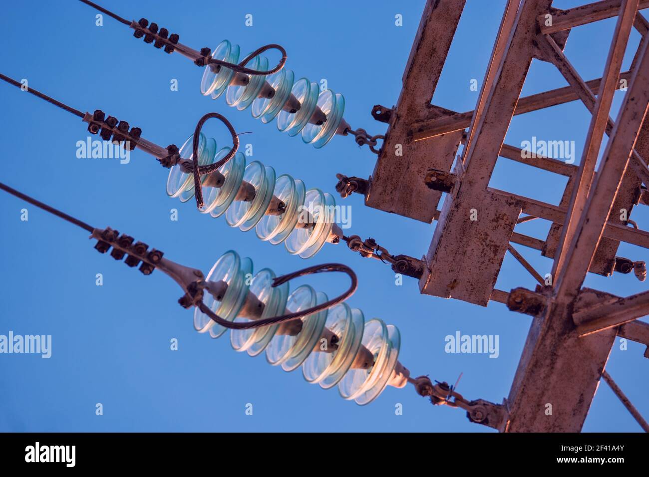 Part of Electricity transmission power line - High voltage tower - with glass insulators in front of the sky. Part of Electricity transmission power line - High voltage tower - with glass insulators Stock Photo