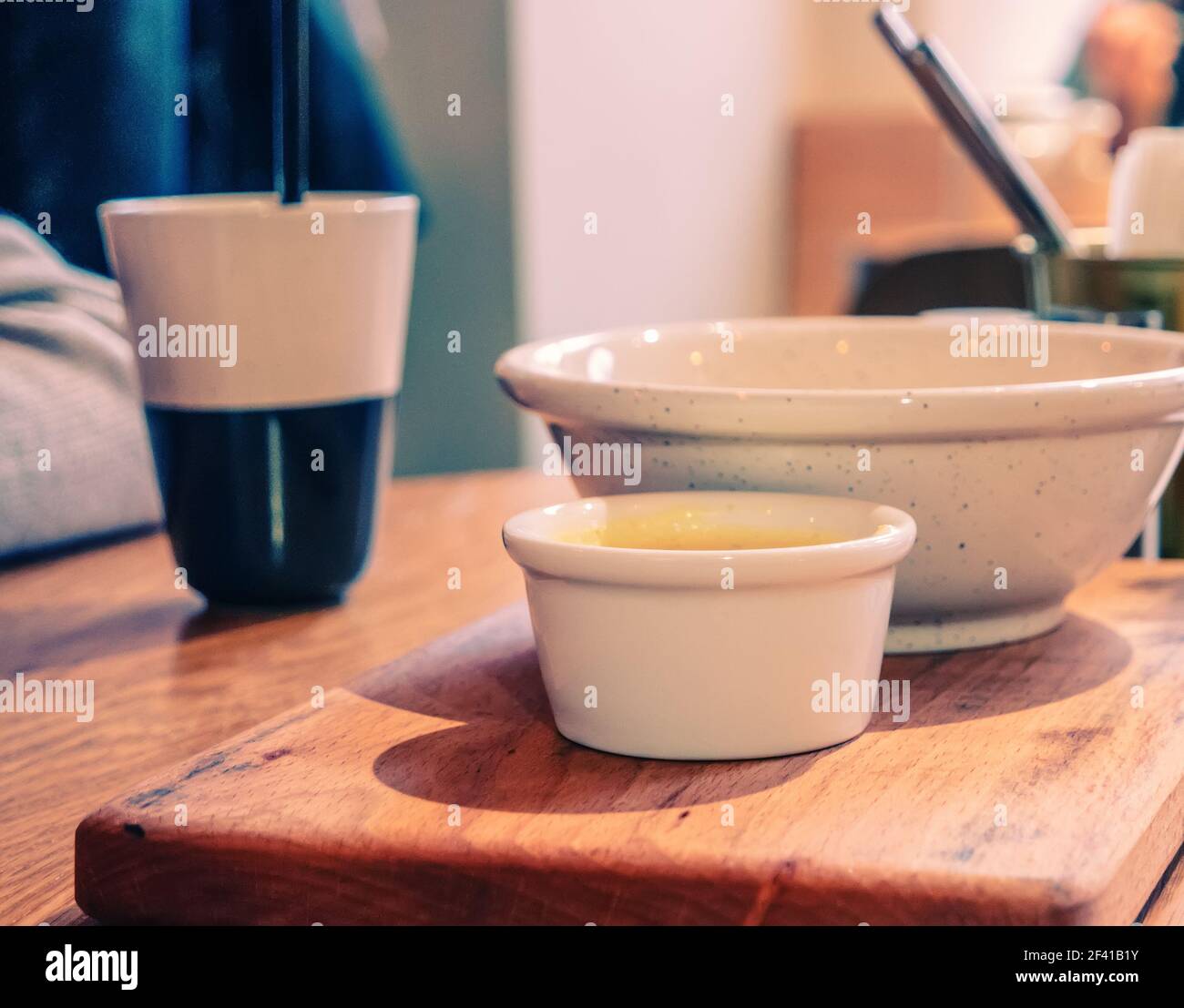 Coffee and bowls of food on table top. Vintage color Image.. Coffee and bowls of food on table Stock Photo