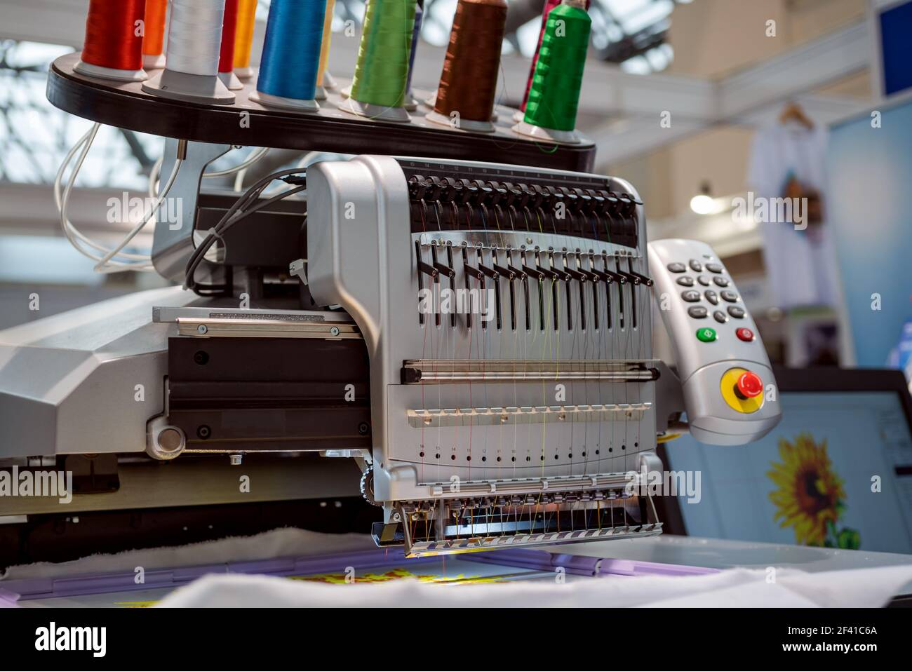 Automatic industrial sewing machine for stitch by digital pattern. Modern textile industry. Stock Photo