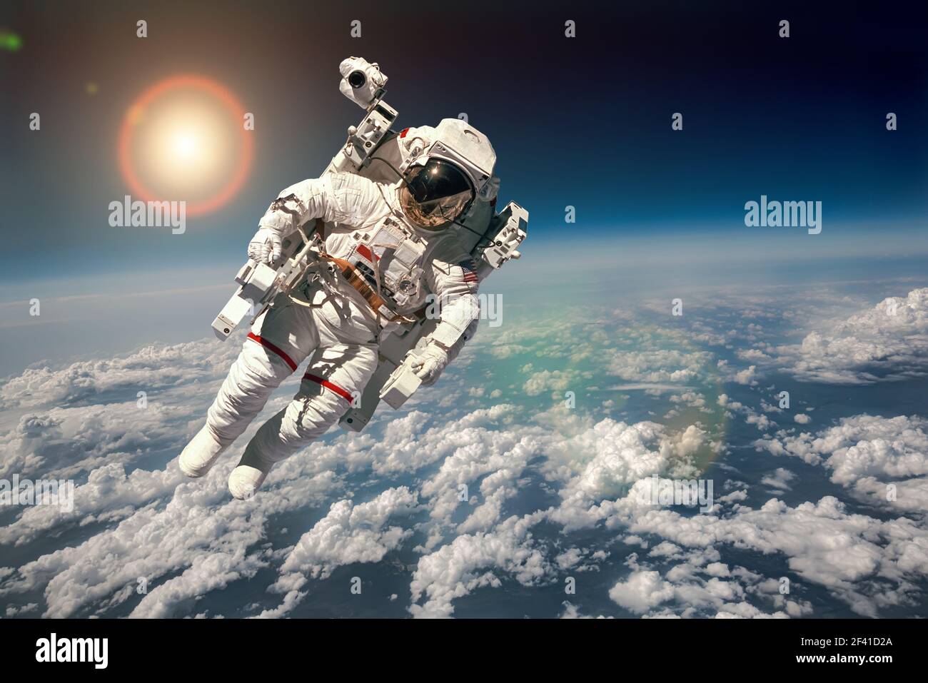Astronaut in outer space against the backdrop of the planet earth. Elements of this image furnished by NASA. Stock Photo