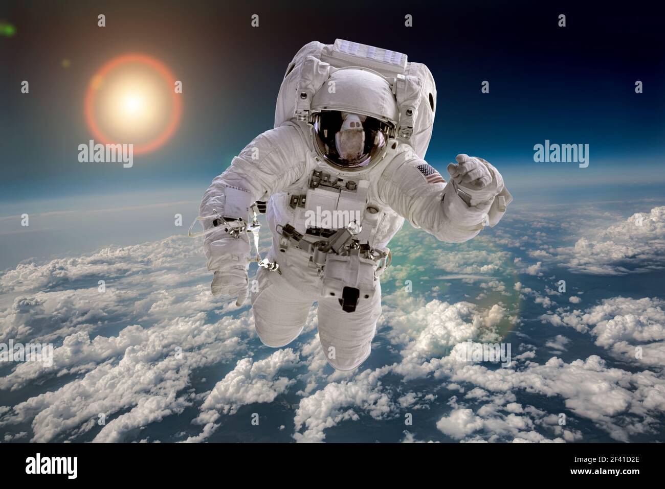 Astronaut in outer space against the backdrop of the planet earth. Elements of this image furnished by NASA. Stock Photo