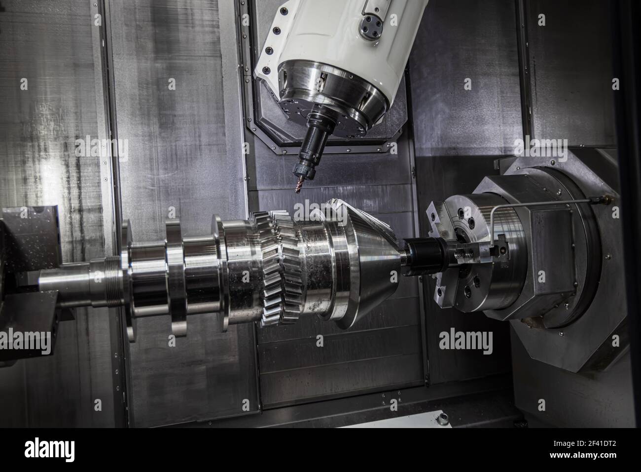 Metalworking CNC lathe milling machine. Cutting metal modern processing technology. Milling is the process of machining using rotary cutters to remove material by advancing a cutter into a workpiece. Stock Photo