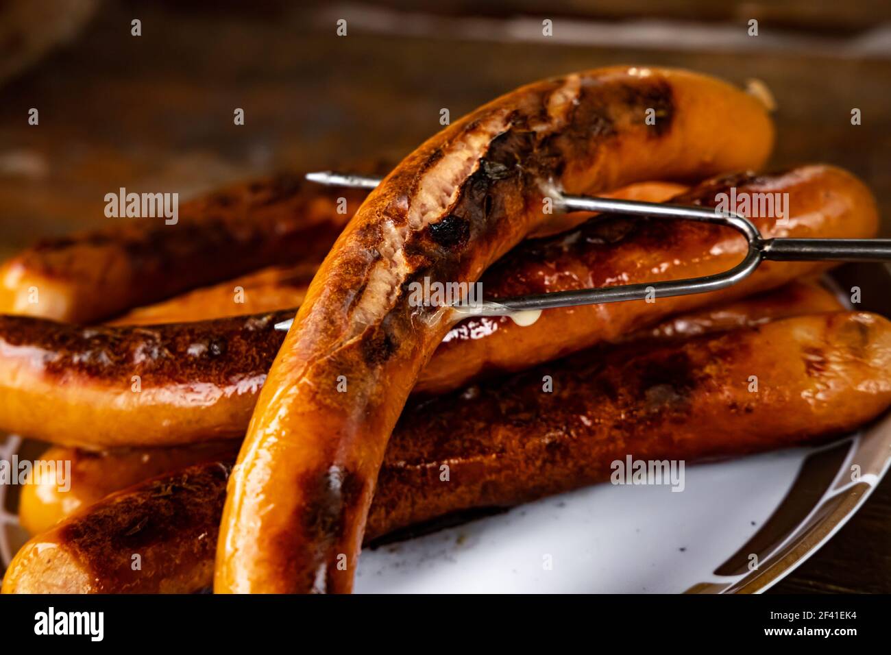 Grilled sausages on wooden board Stock Photo