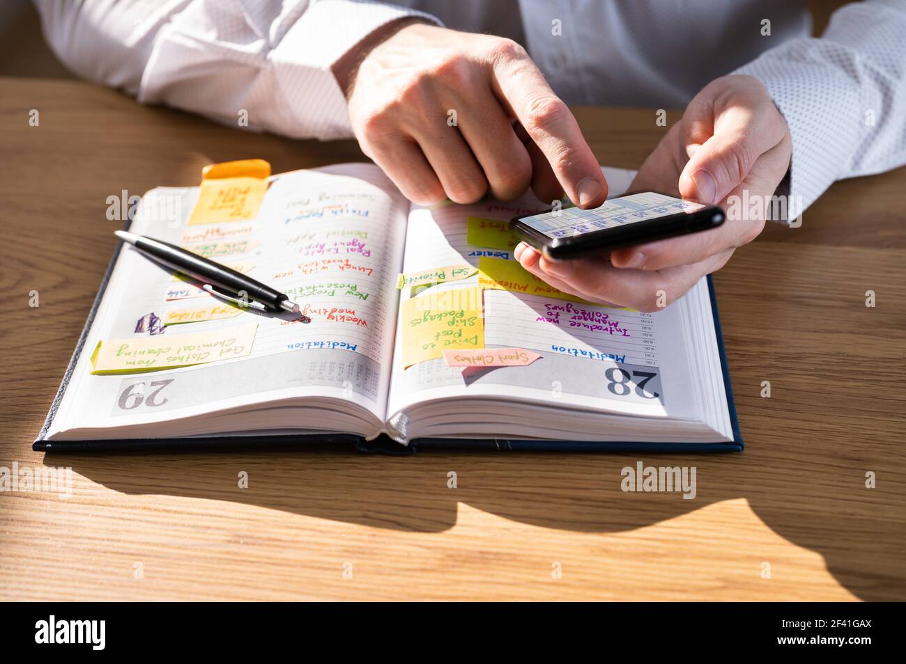 Writing Agenda Week Plan List Using Mobile Phone Stock Photo