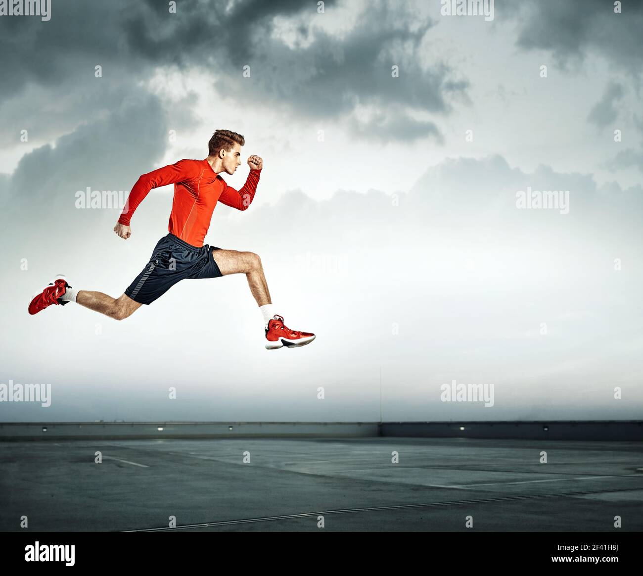 Young and handsome athlete running Stock Photo