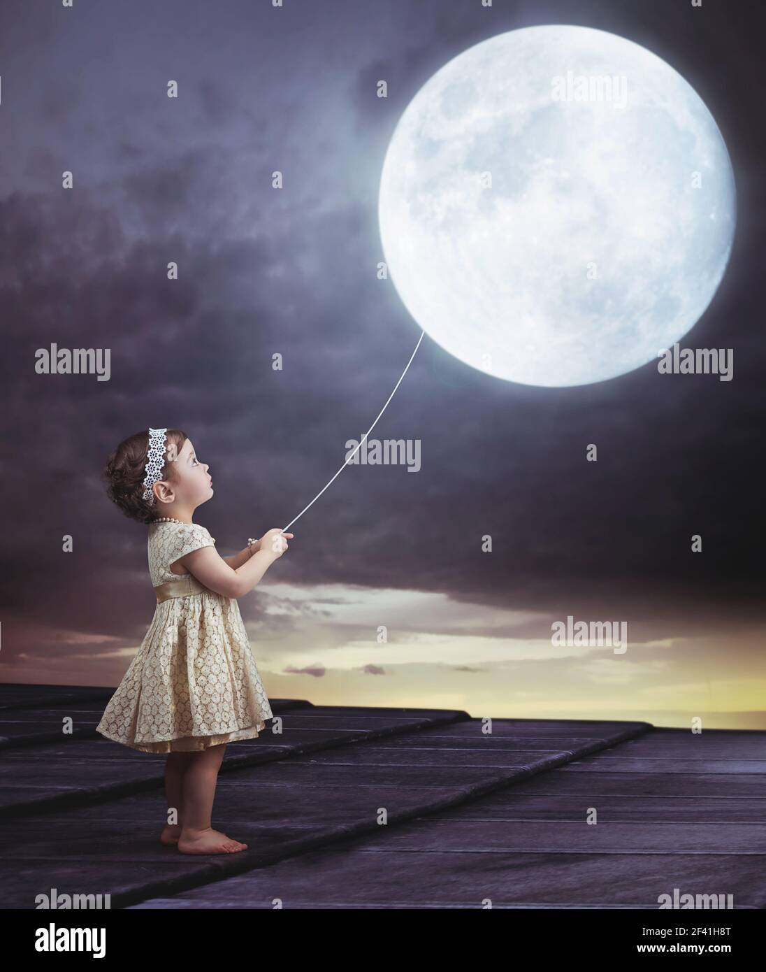Fairy portait of a little cute girl with a moony balloon Stock Photo