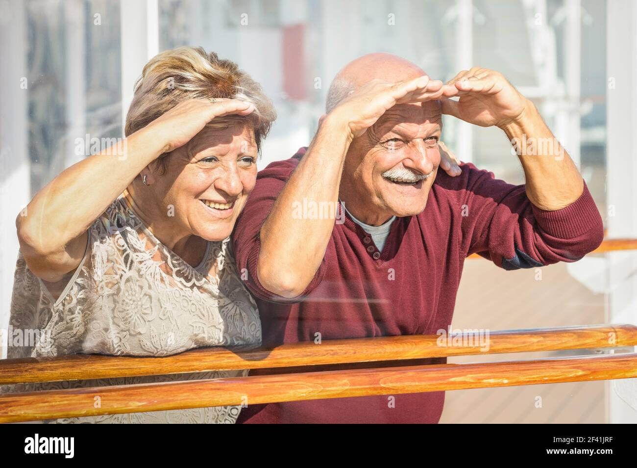 Happy senior couple having fun looking to future - Concept of active playful elderly during retirement - Travel lifestyle with childish funny attitude Stock Photo