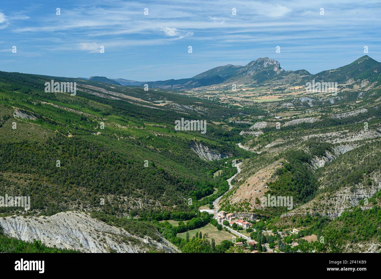 Aerial panoramic view of a green valley surrounded by tall mountains near Annecy, France. Stock Photo