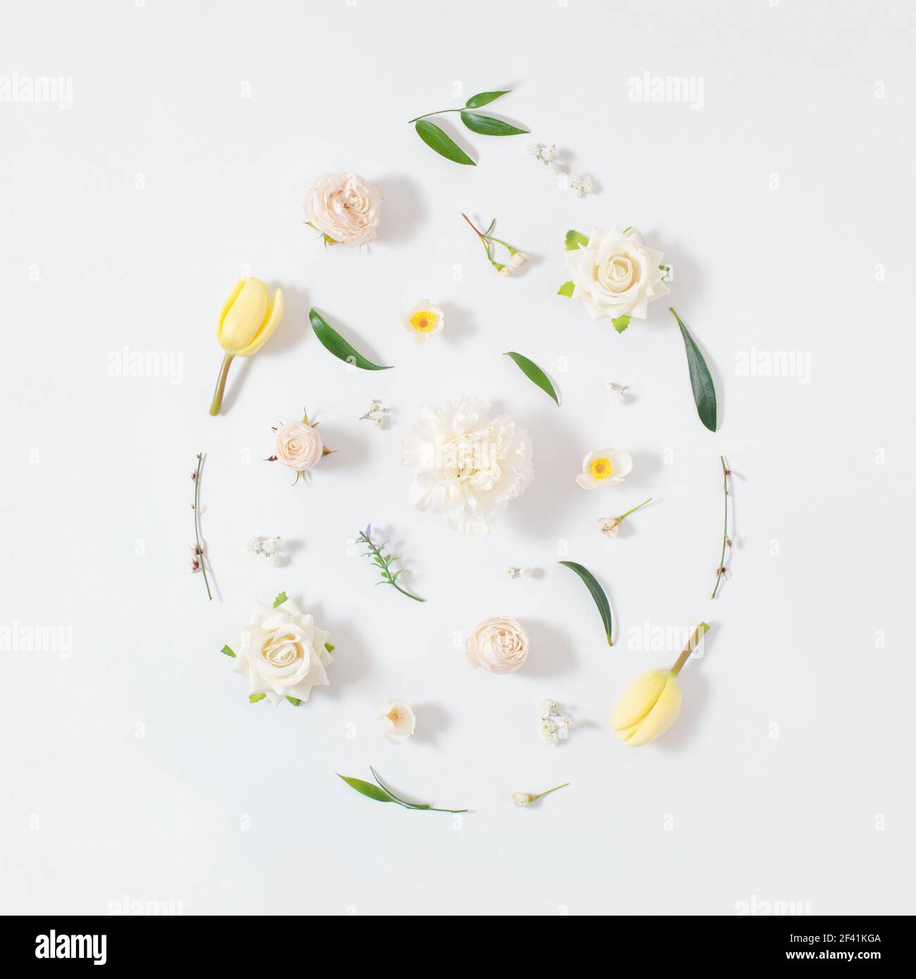 2021 Easter egg shape arrange from colorful  spring flowers and green leafs over white background.  Minimal flat lay holiday concept. Stock Photo