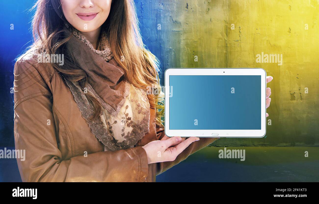 Attractive young woman holding a tablet Stock Photo