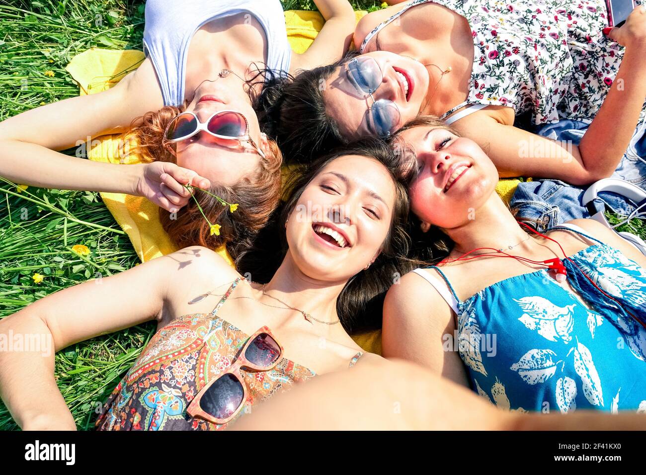 Multiracial girlfriends taking selfie at countryside picnic - Happy friendship concept and fun with young people and new technology trend Stock Photo