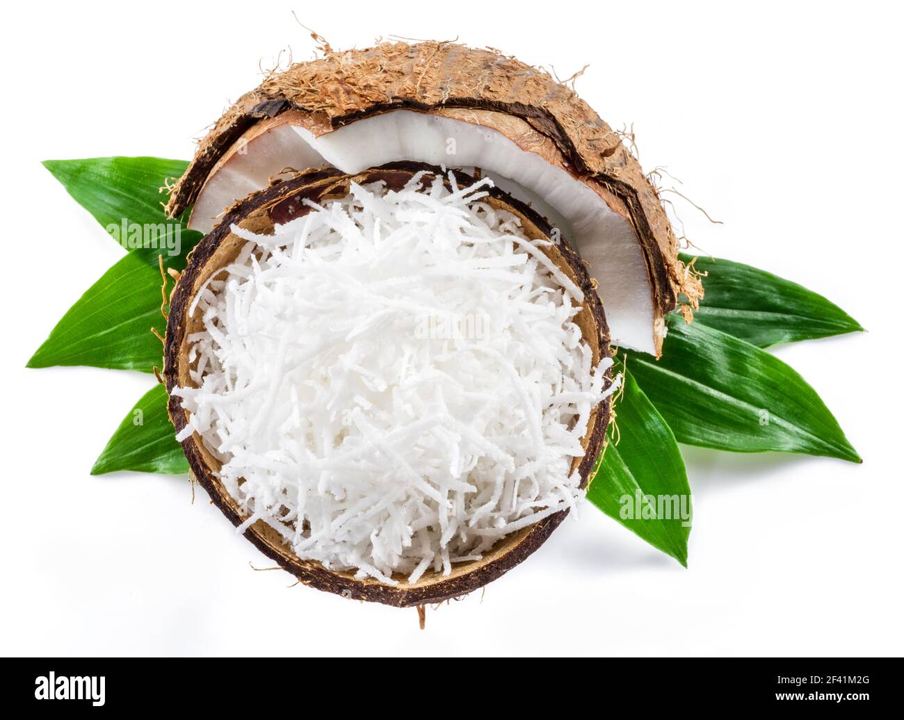 Shredded coconut flakes in the piece of coconut shell isolated on white