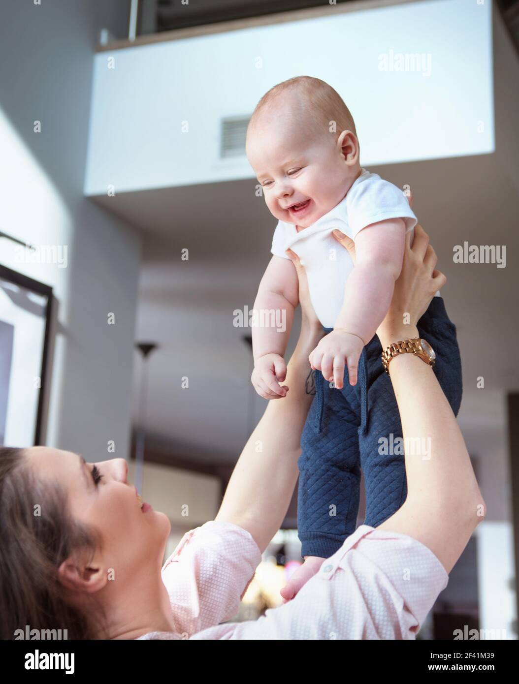 Young woman carrying her cute, little son Stock Photo