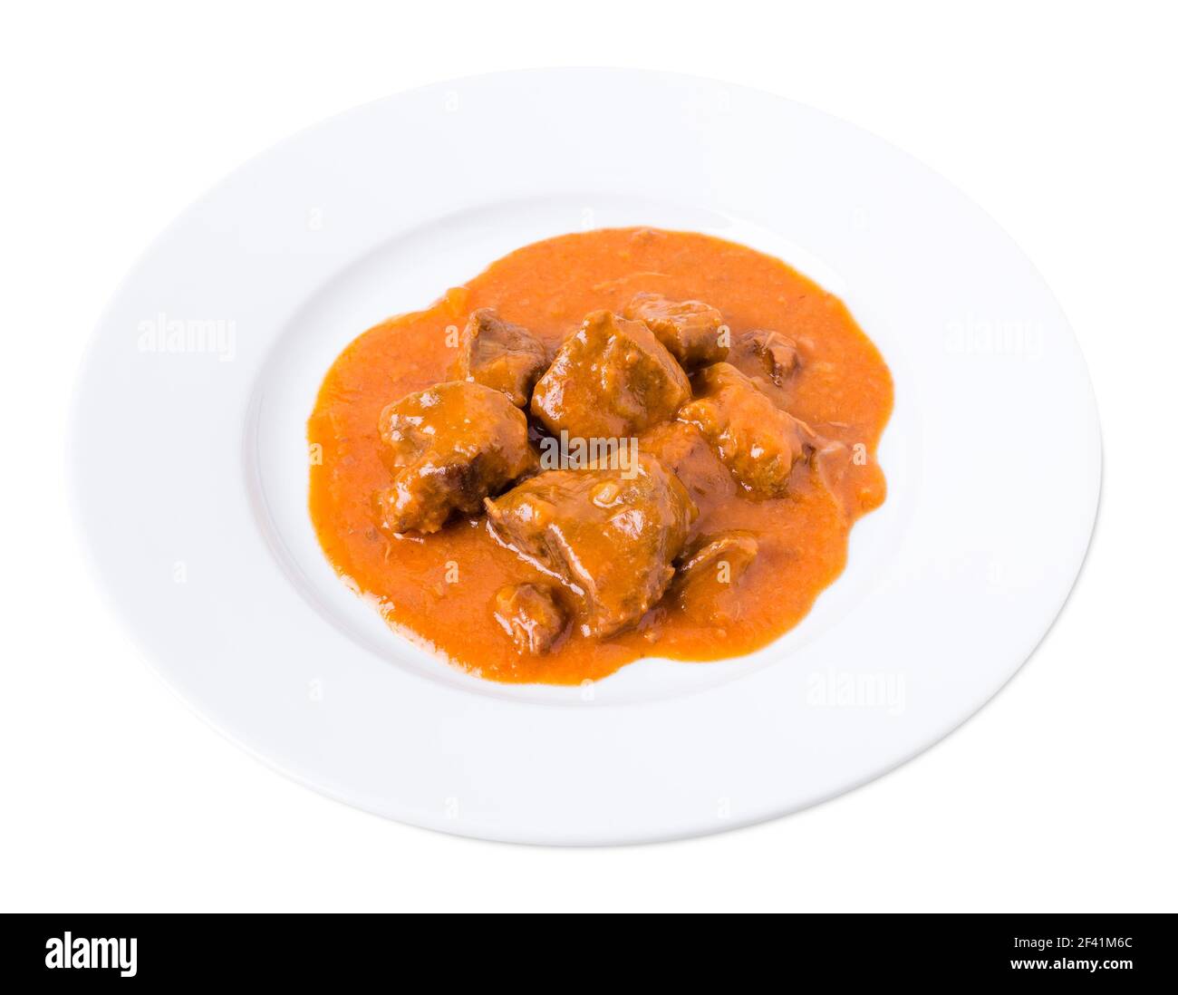 Delicious beef in tomato sauce. Isolated on a white background Stock