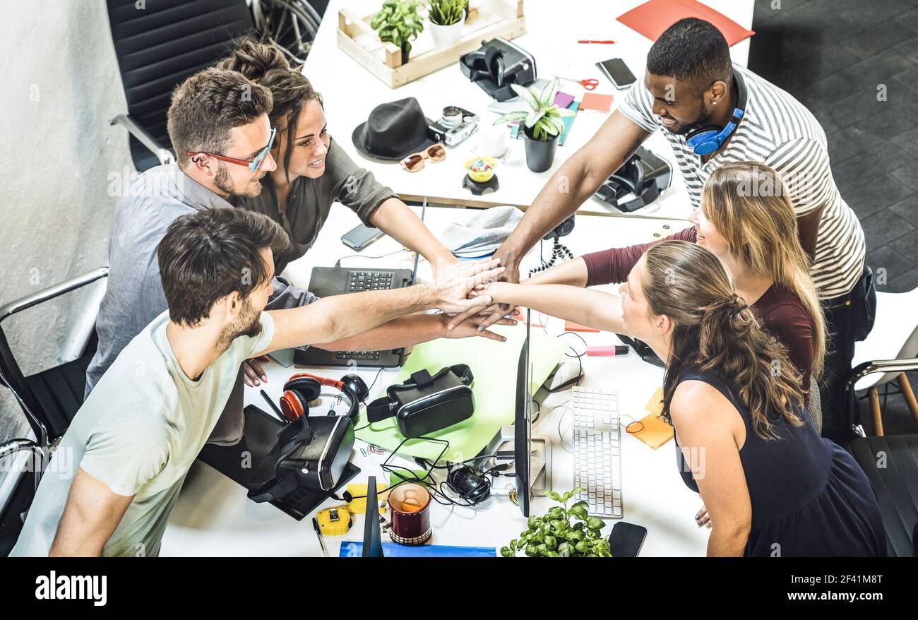 Young employee startup workers group stacking hands at urban studio during entrepreneurship brainstorming project - Business concept of human resource Stock Photo