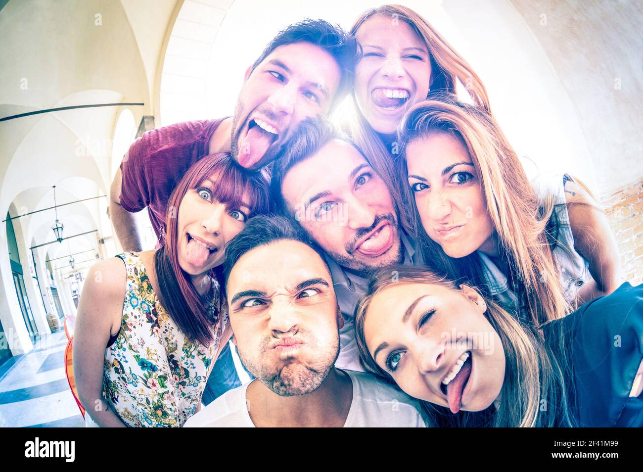 Best friends taking selfie outdoors with back lighting - Happy friendship concept with young people having fun together - Cold vintage filtered look Stock Photo