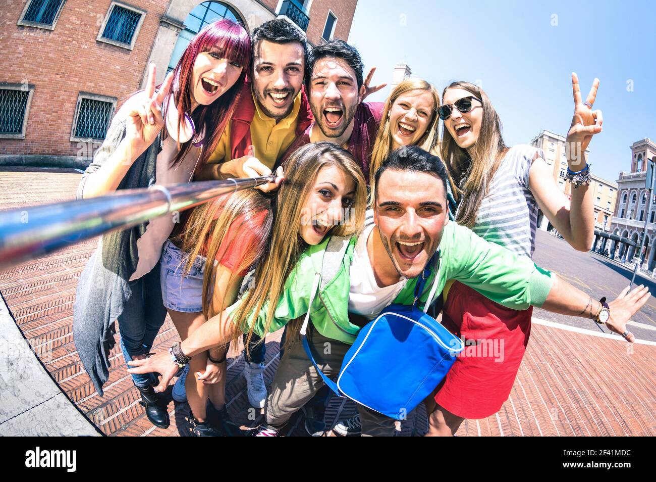 Group of multicultural tourists friends having fun taking selfie and shouting out at old town tour -Travel lifestyle concept with happy people Stock Photo