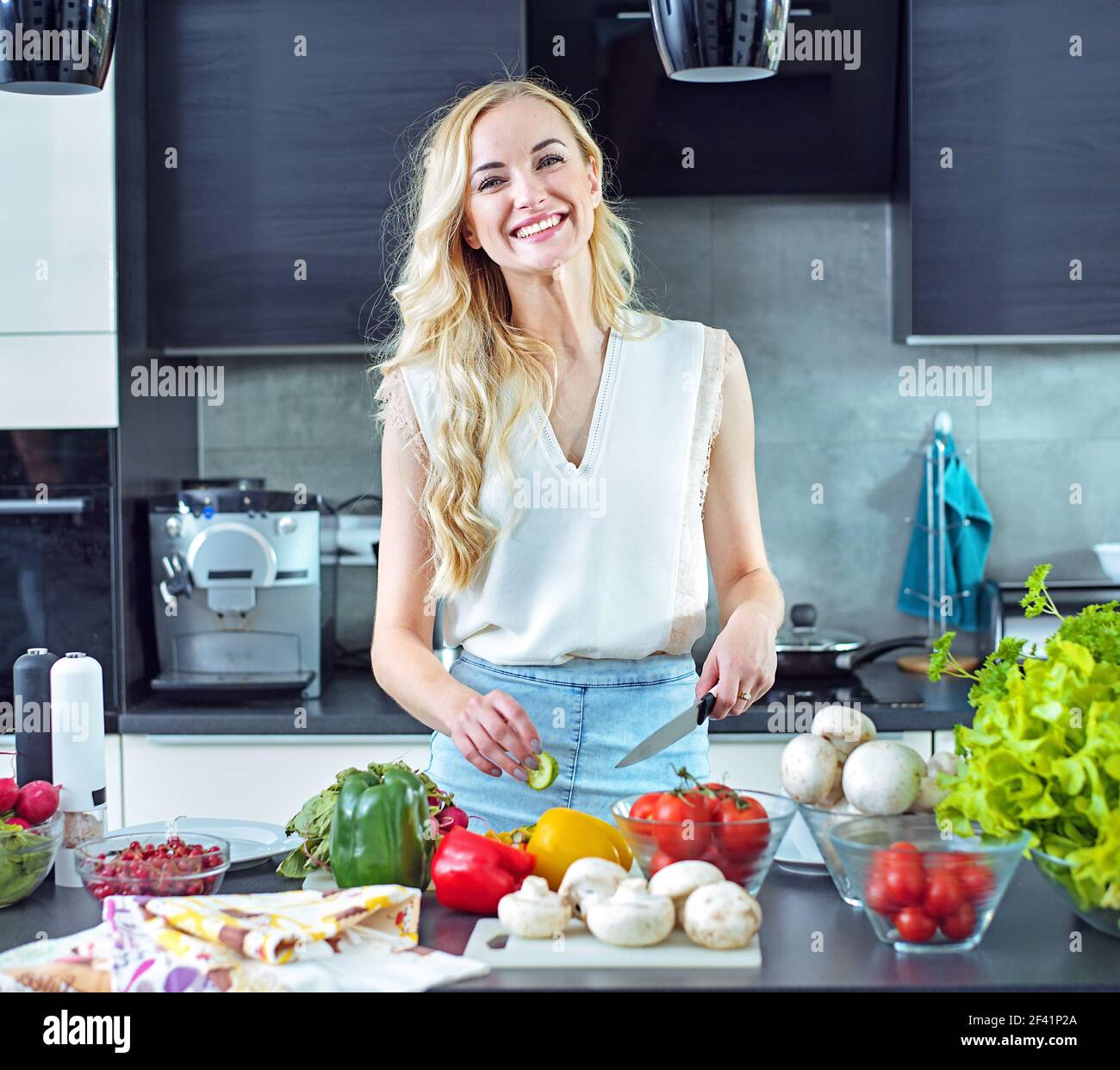 Cheerful blonde making a helathy, light lunch Stock Photo