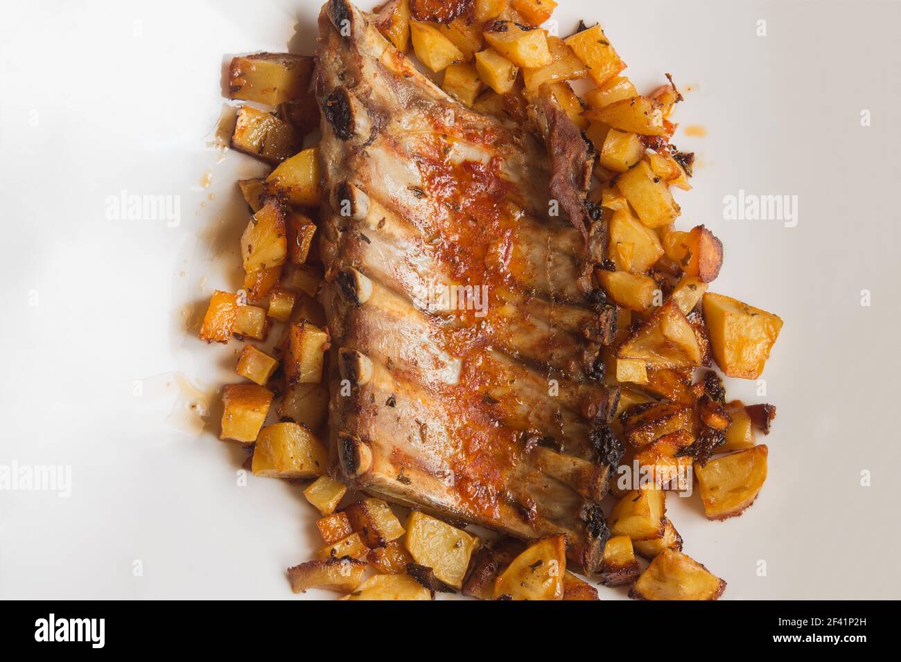 Tasty cooked dish of baked pork ribs in a garlic sauce, oil, vinegar