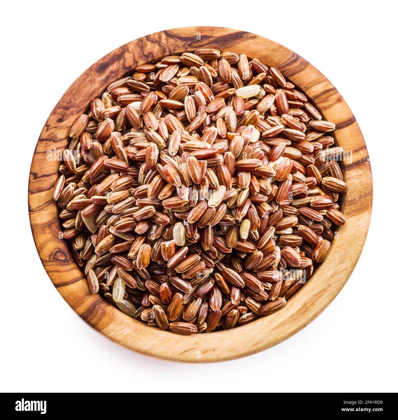 Brown rice - whole grain rice with outer hull or husk in wooden bowl on white background. Top view. File contains clipping path. Stock Photo