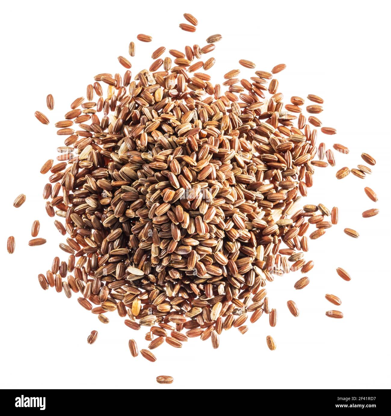 Brown rice heap - whole grain rice with outer hull or husk. Top view. Stock Photo