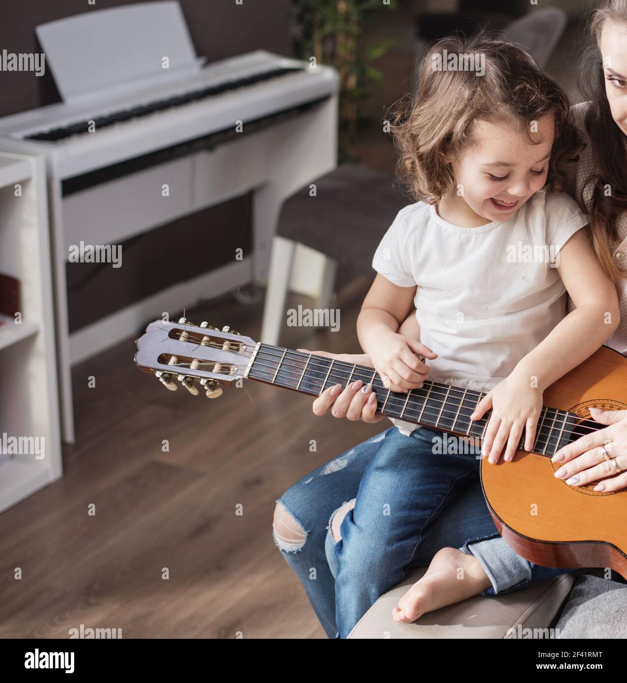 Mother and daughter playing a classic guitar Stock Photo Alamy