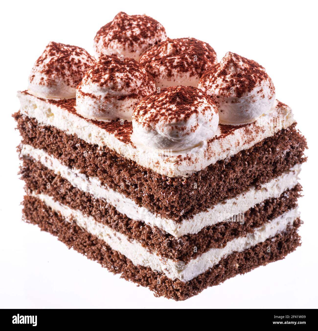 Slice of chocolate cake with tiramisu cream and cocoa powder isolated on white background. Stock Photo