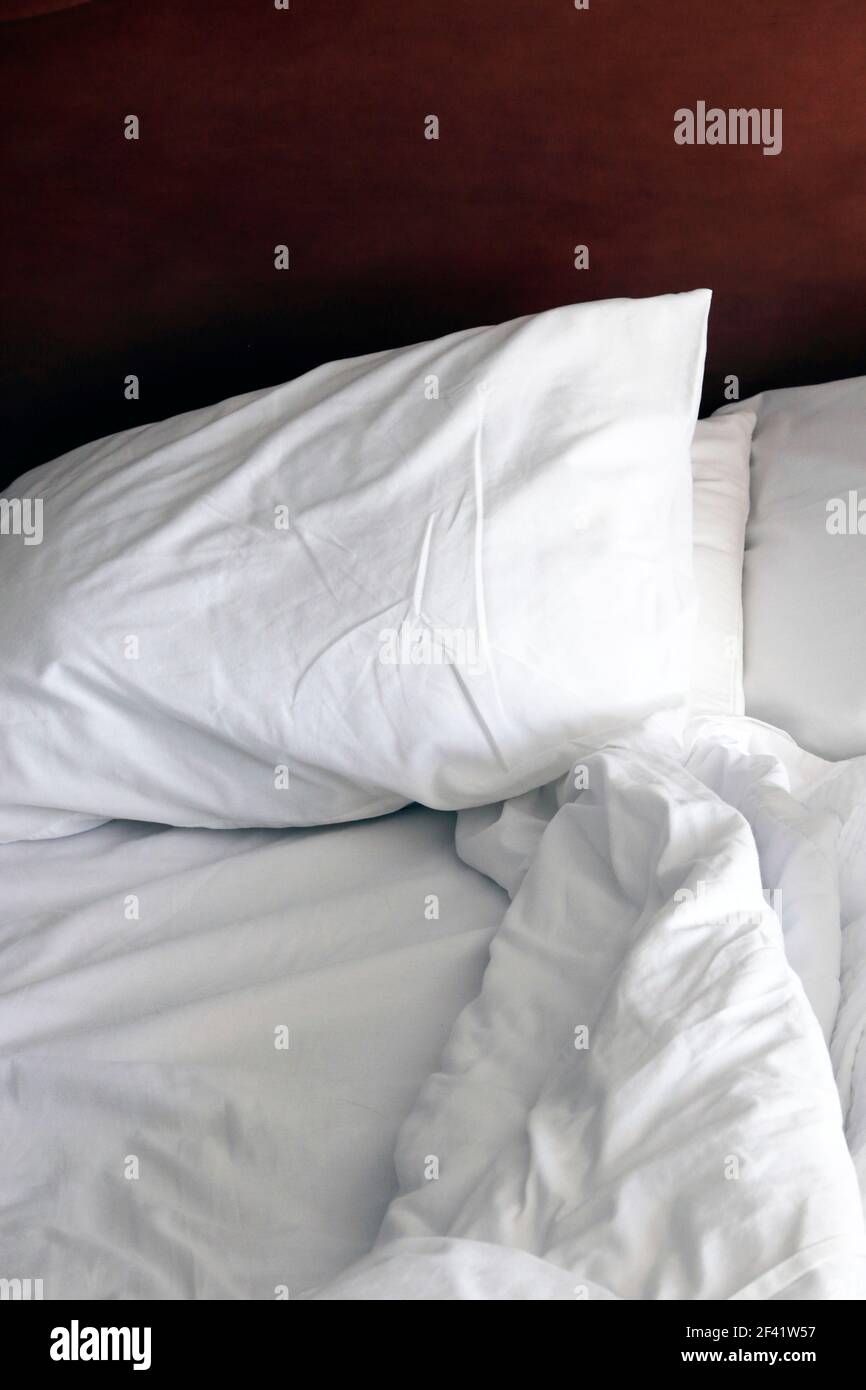 An empty but used an rumpled bed. Stock Photo
