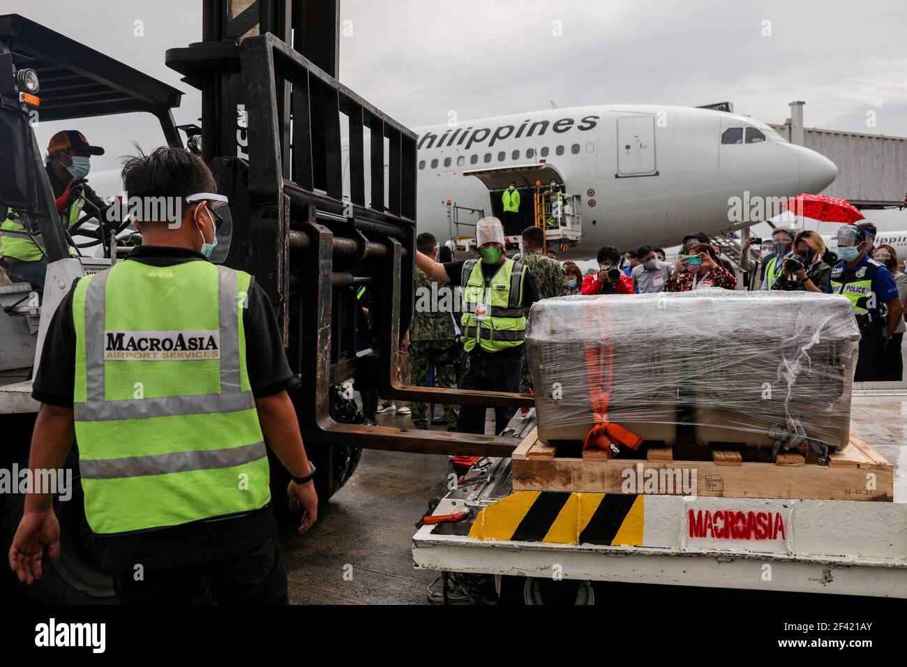 Airport personnel transfer crates of mock vaccines during a simulation at the Ninoy Aquino International Airport (NAIA) Terminal 2 in Pasay City, Metro Manila, Philippines. Stock Photo