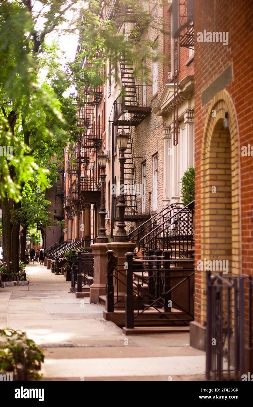 Street scene of residential neighborhood with a row of buildings seen from New York City Manhattan Stock Photo