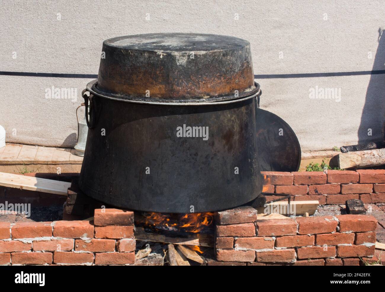 A closeup shot of an old metal pot on a bonfire outdoors Stock Photo