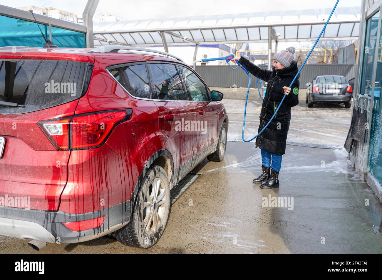 washing car at autowash . Car wash. red machine under the pressure of