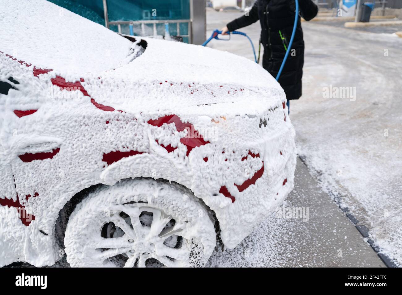 washing car at autowash . Car wash. red machine under the pressure of