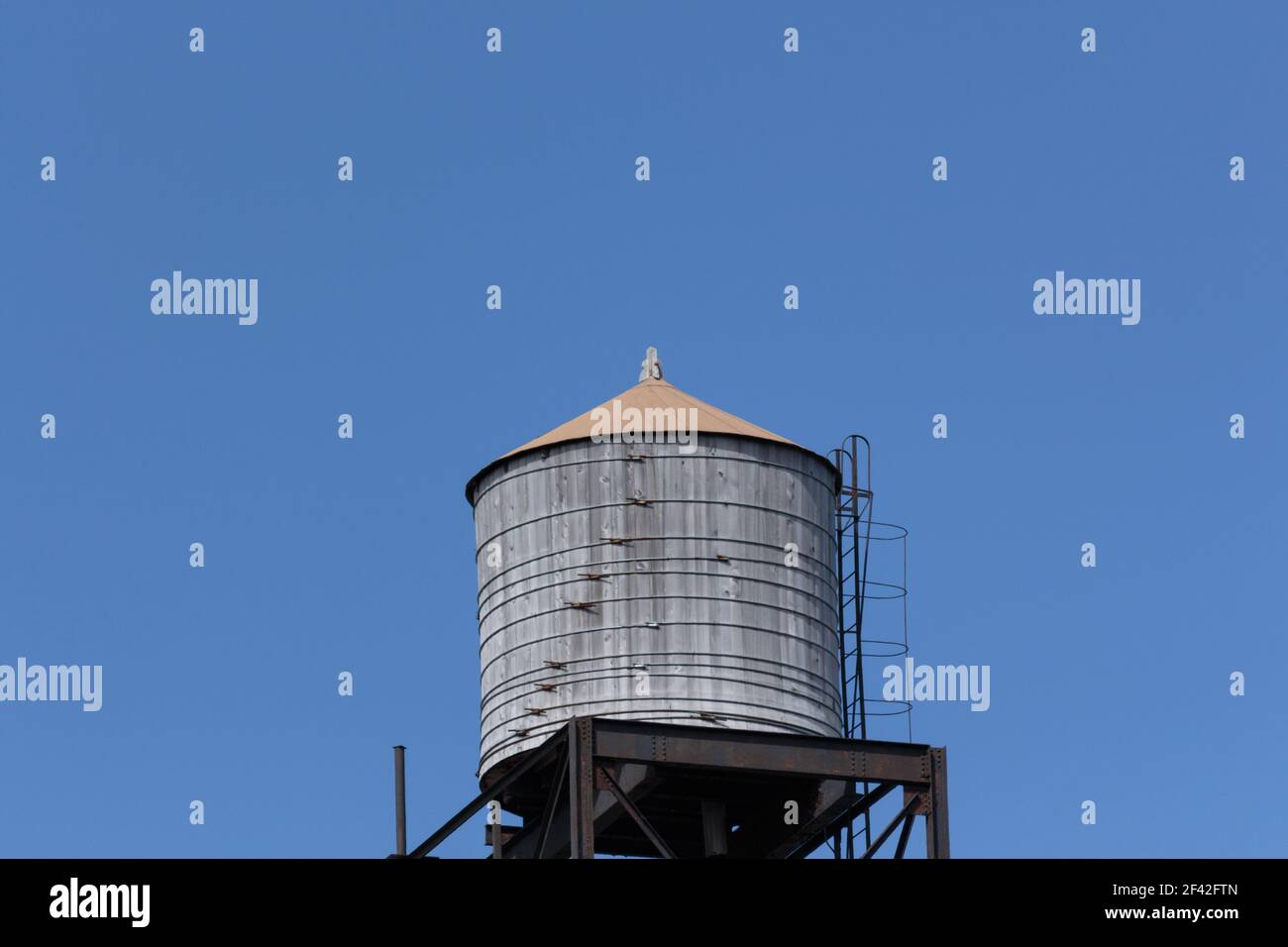 rooftop water tank against a clear blue sky with copy space Stock Photo