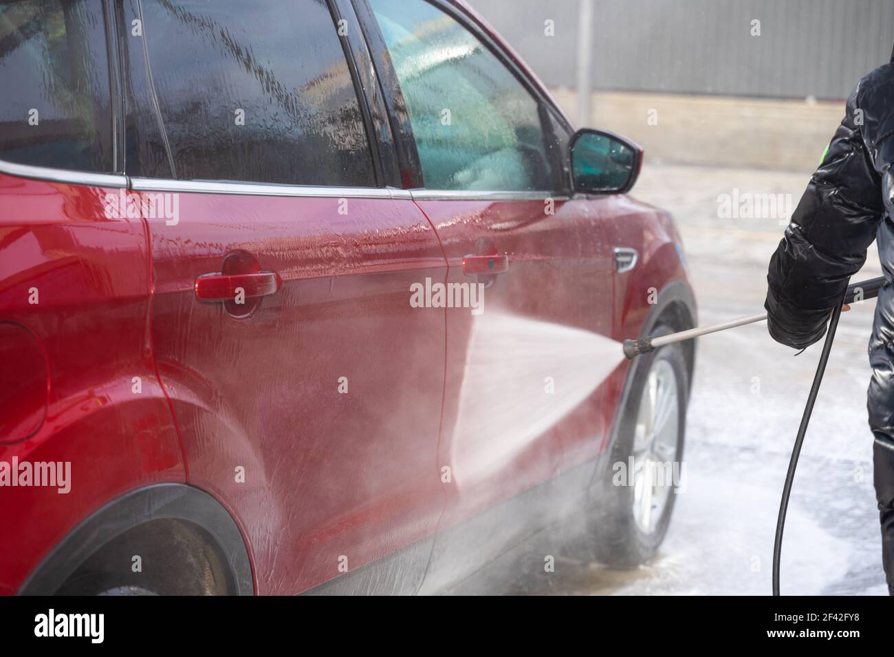 washing car at autowash . Car wash. red machine under the pressure of