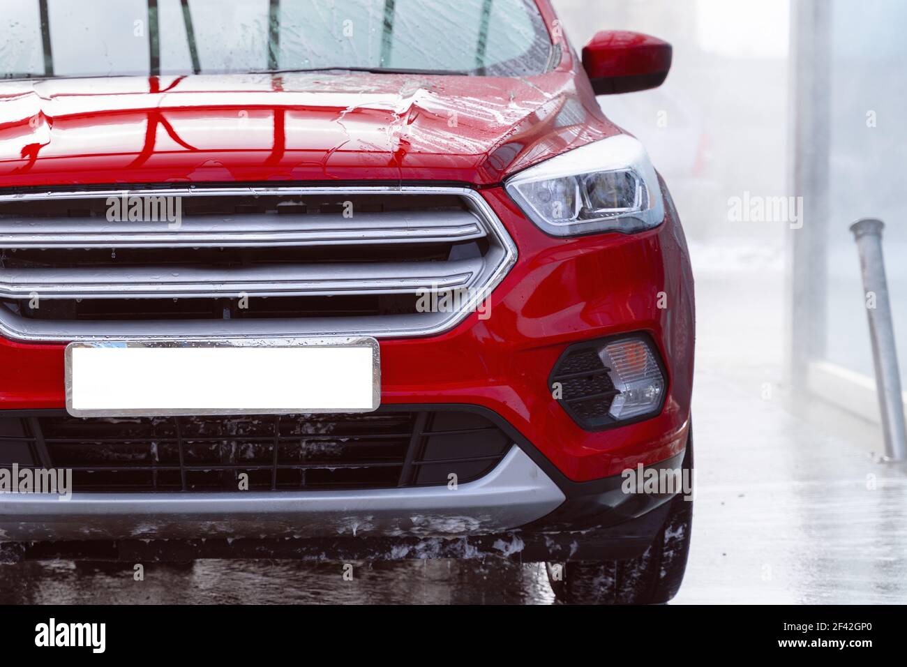 washing car at autowash . Car wash. red machine under the pressure of