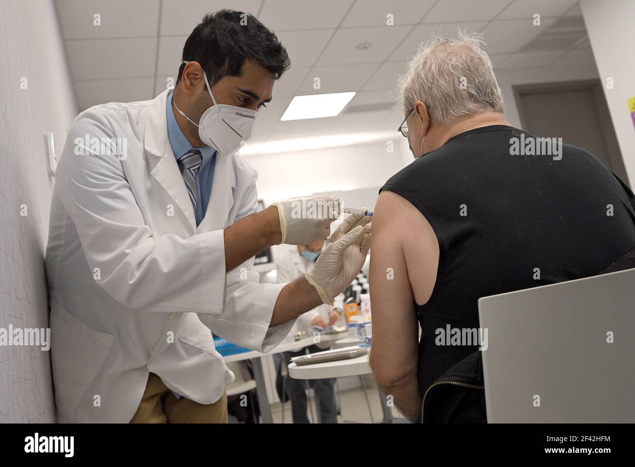 New York, USA. 18th Mar, 2021. Pharmacist Ambar Keluskar injects a man with his first dose of