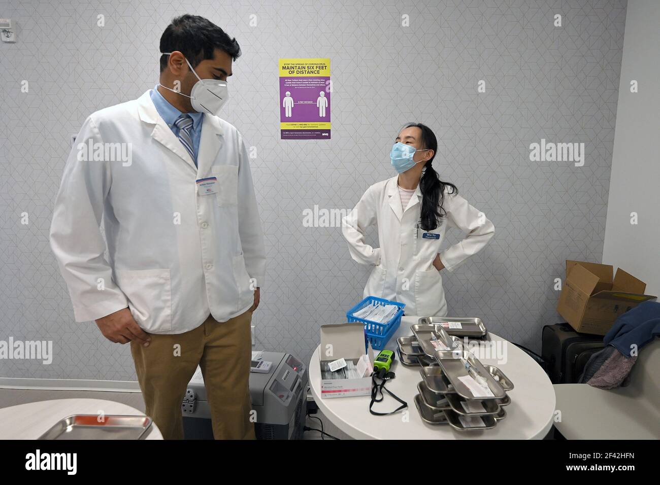 New York, USA. 18th Mar, 2021. Pharmacist husband and wife team Ambar Keluskar and Mia Yu pause