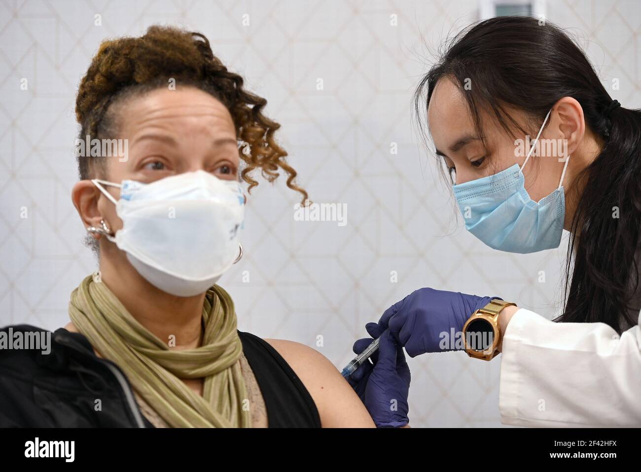 New York, USA. 18th Mar, 2021. Deborah Cole reacts as she receives her first dose of the Moderna